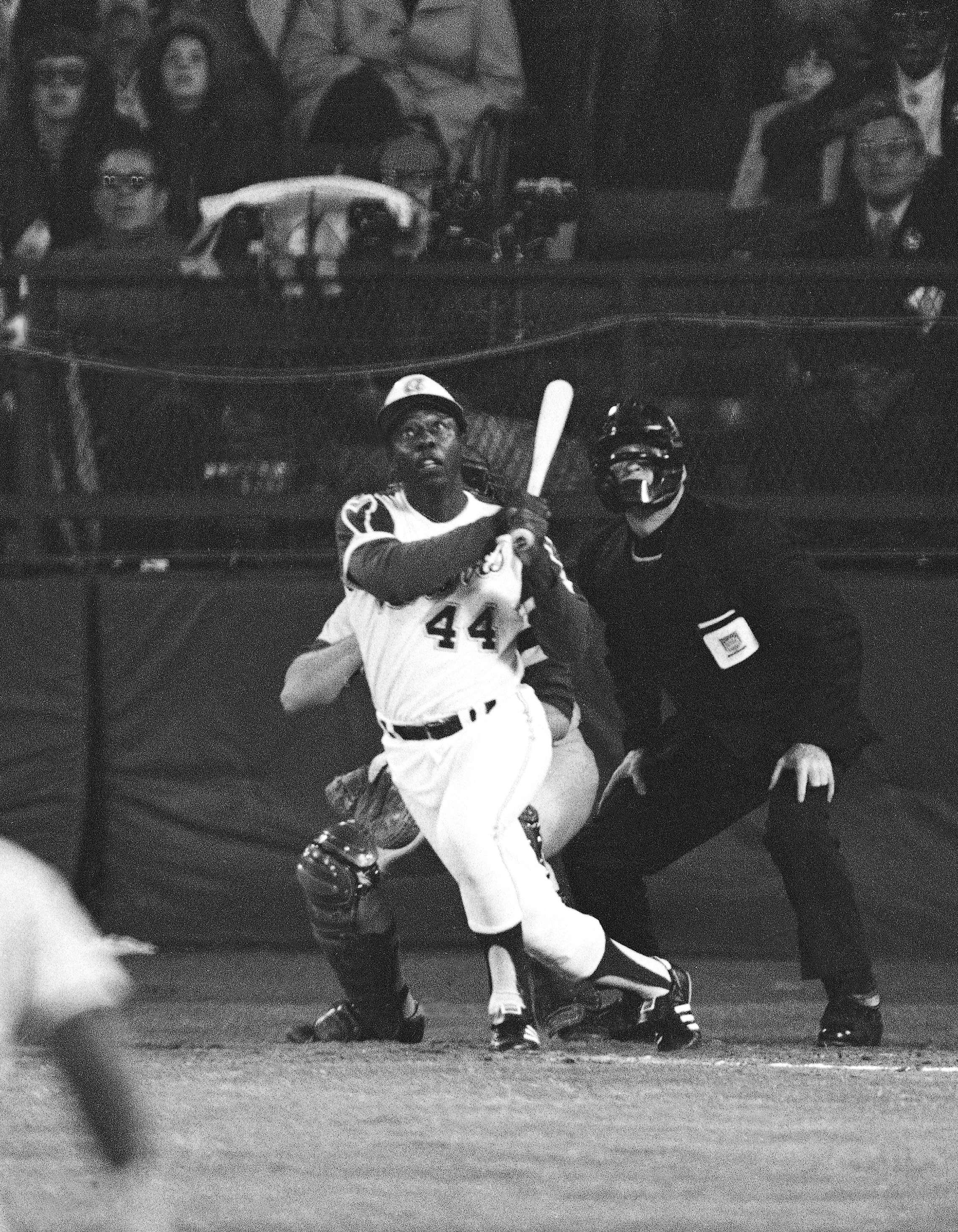 April 8, 1974: Hank Aaron watches his 715th career home run sail over the outfield fence, breaking the record set by Babe Ruth in 1935.
