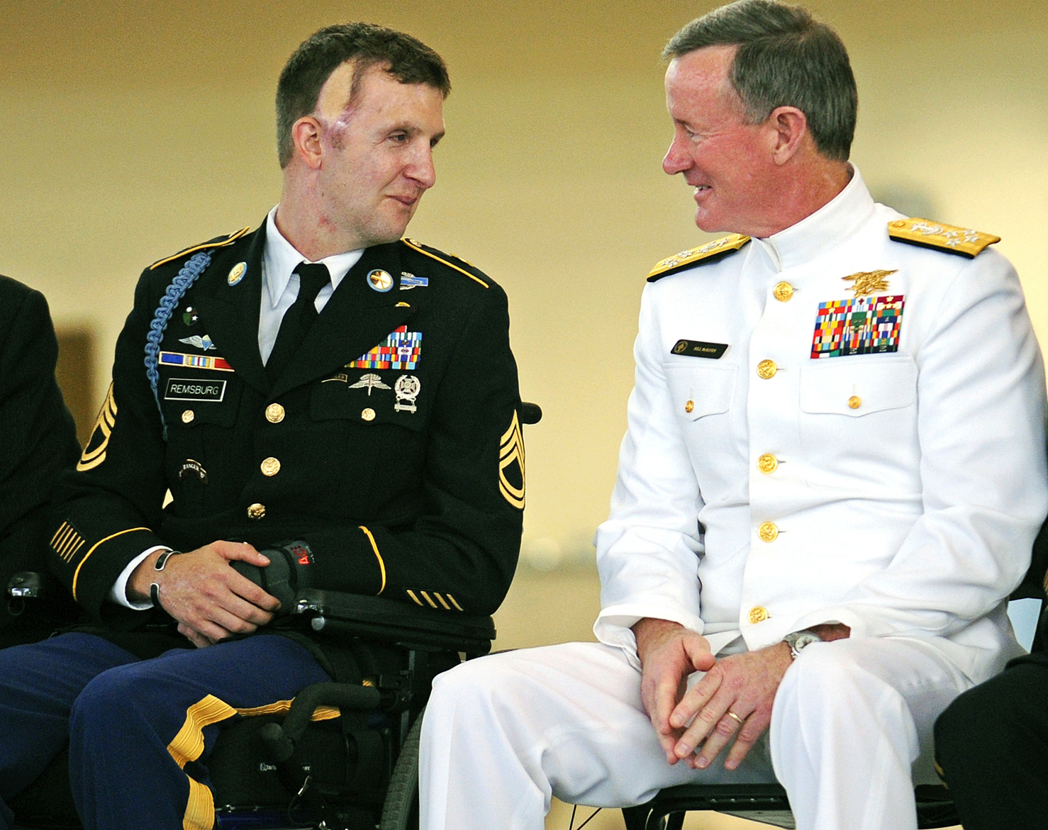 Sgt. Cory Remsburg, USA, speaks with Admiral William McRaven, during Remsburg's 2014 retirement ceremony. An Army Ranger, Remsburg was severely wounded in a 2009 firefight with enemy forces in Afghanistan. He has since become a national figure who was highlighted during President Obama's 2014 State of the Union Address. (AP Photo/Savannah Morning News, Corey Dickstein)