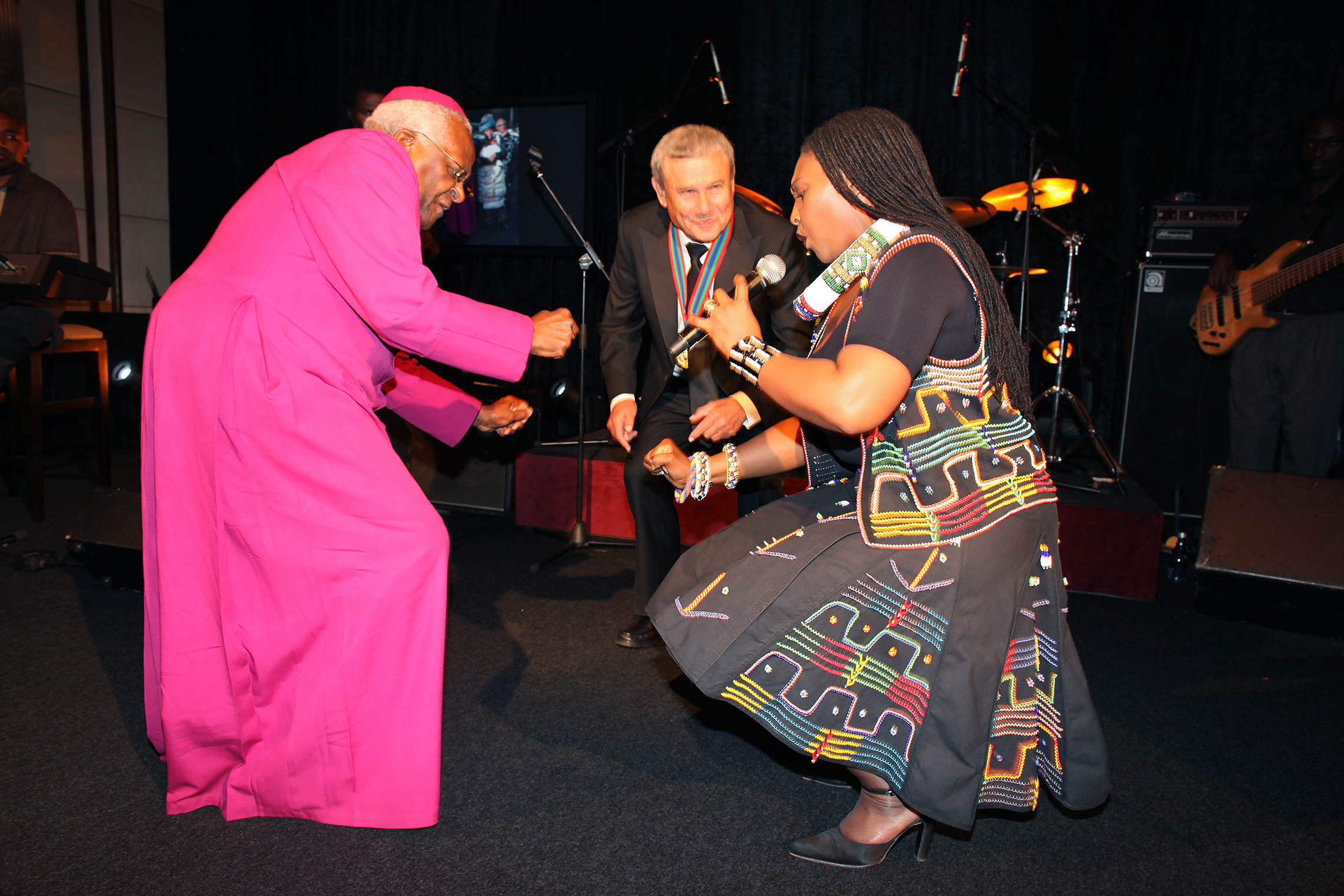 Archbishop Desmond Tutu dances at the 2009 International Achievement Summit in Cape Town, South Africa, with hotel magnate Sol Kerzner during the performance of Yvonne Chaka Chaka, the "Princess of Africa."